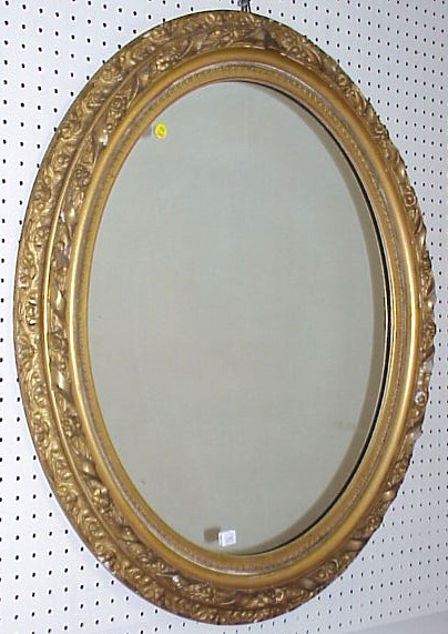 Appraisal: th C oval gilt frame mirror diagonal ribbon and floral