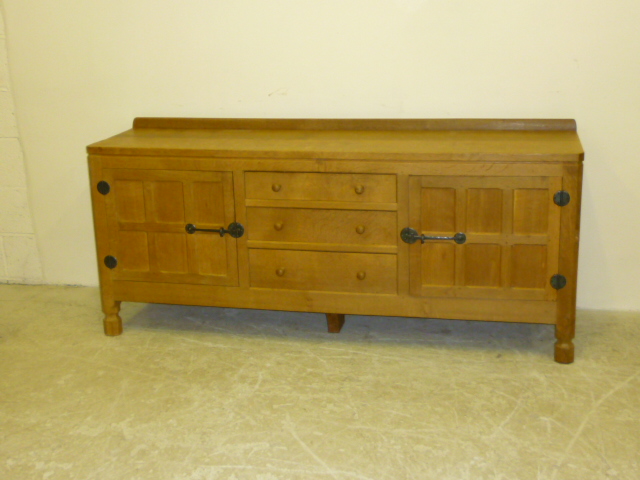 Appraisal: AN ADZED OAK SIDEBOARD by Robert Mouseman Thompson with ledge