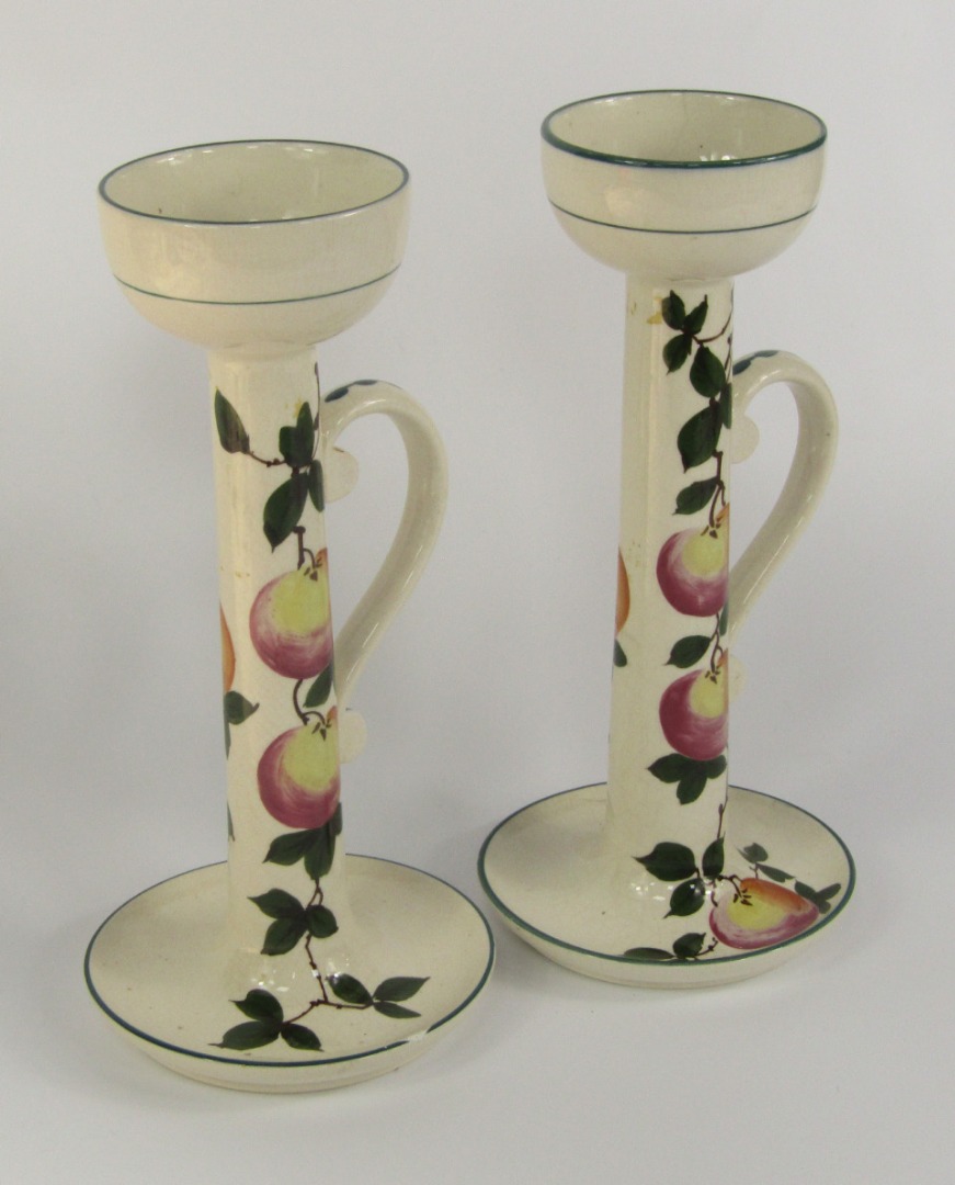 Appraisal: A pair of Wardle Pottery Pamona ware candlesticks of chamberstick