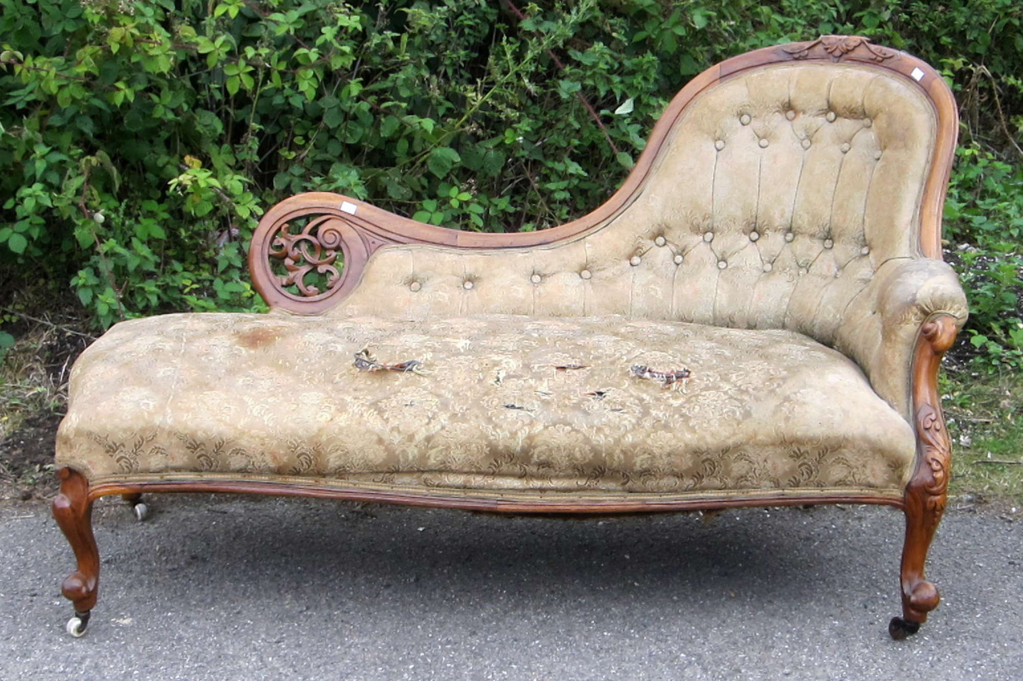 Appraisal: Victorian button back chaise longue with carved walnut showframe on