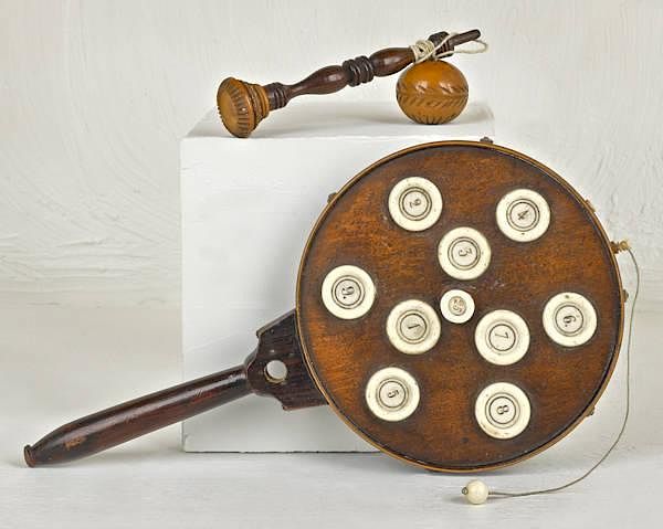 Appraisal: Two wooden dexterity ball catch toys the largest Two wooden