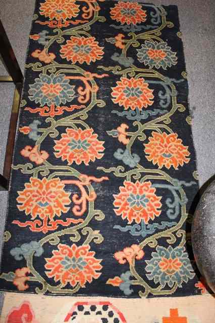 Appraisal: A CHINESE RUG possibly fragment with stylised dragons x and