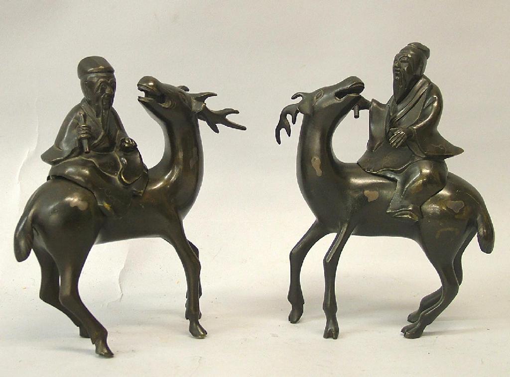 Appraisal: Pair of Japanese bronze Dignitaries holding scrolls and seated upon