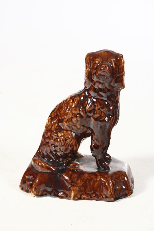 Appraisal: ROCKINGHAM DOG American mid th century Seated spaniel on a