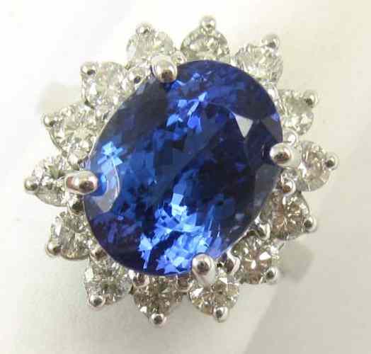 Appraisal: TANZANITE DIAMOND AND FOURTEEN KARAT GOLD RING round-cut diamonds surround