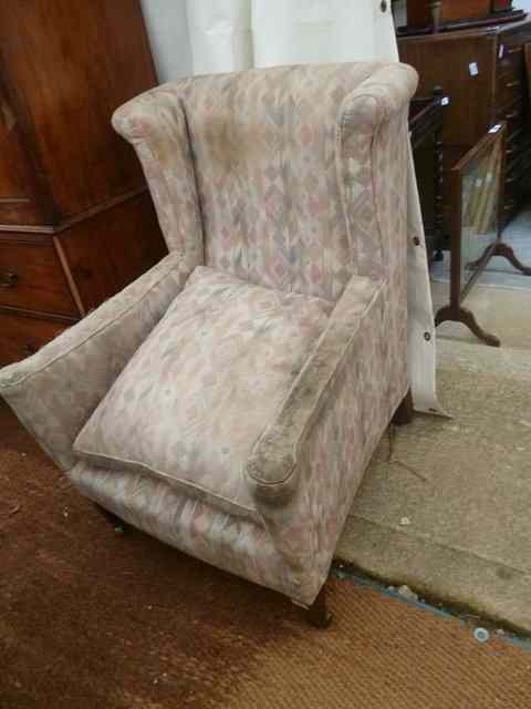 Appraisal: A WING BACK ARMCHAIR on square tapering legs terminating in