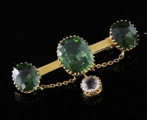 Appraisal: A peridot and diamond bar brooch the bar with central