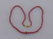 Appraisal: A red coral and bead necklace the vibrant red graduated