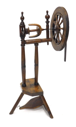 Appraisal: A principally thC oak spinning wheel with articulated wheel turned