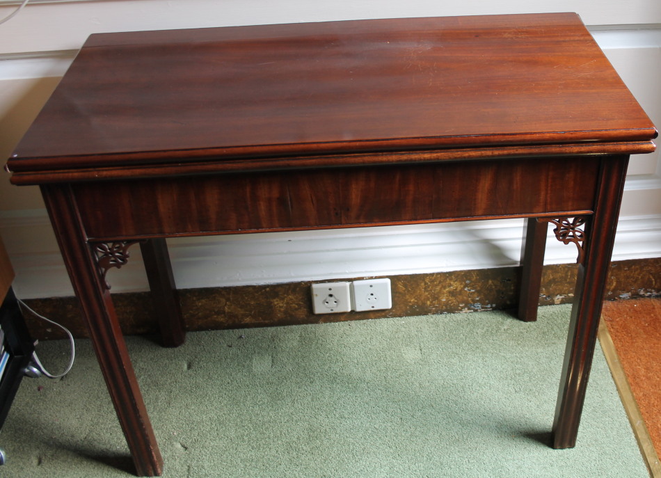 Appraisal: A George III mahogany card table the rectangular top with