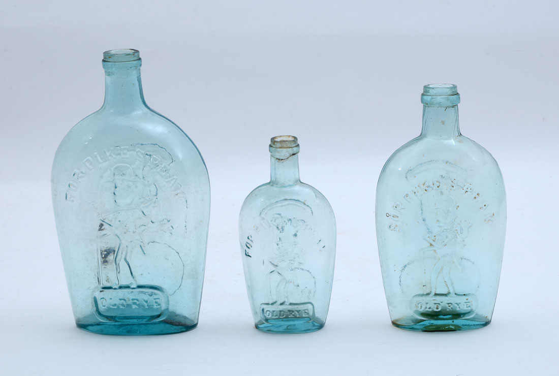 Appraisal: FOR PIKE'S PEAK HISTORICAL GLASS FLASKS A graduated set of