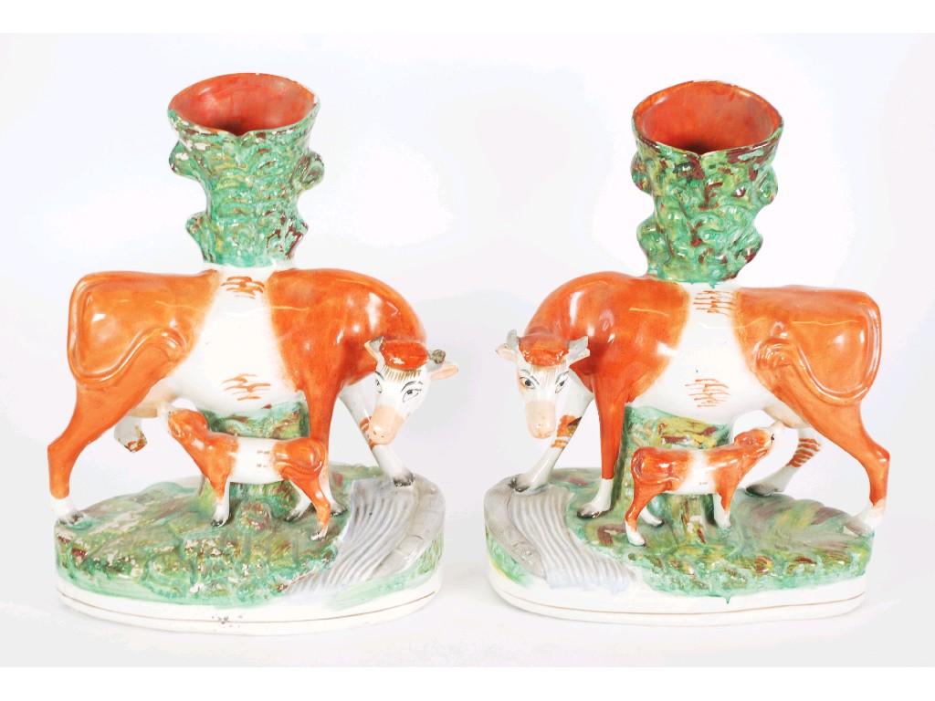 Appraisal: PAIR OF NINETEENTH CENTURY STAFFORDSHIRE POTTERY SPILL VASE GROUPS modelled