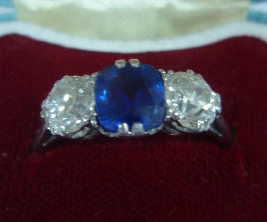 Appraisal: A sapphire and diamond three stone ring the central claw