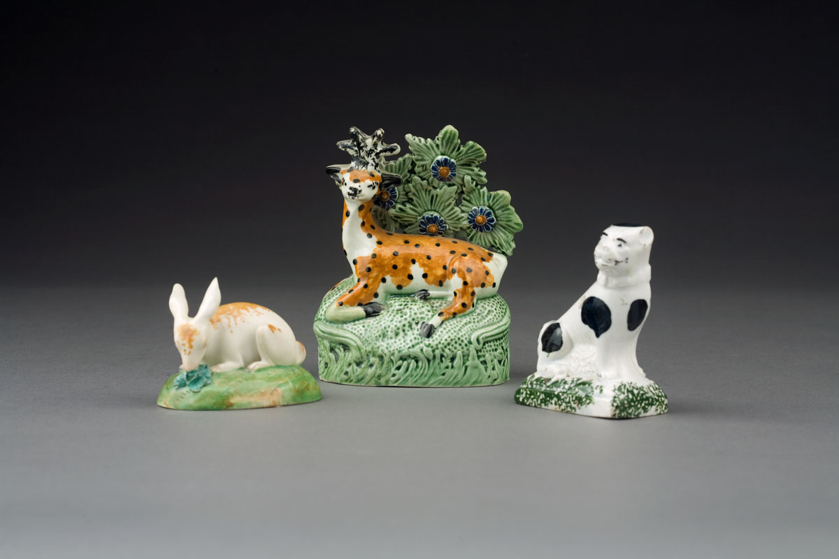 Appraisal: THREE STAFFORDSHIRE PEARLWARE FIGURES OF ANIMALS EARLY-MID NINETEENTH CENTURY Comprising