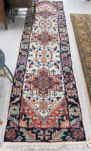 Appraisal: HAND KNOTTED ORIENTAL RUNNER Indo-Heriz overall color floral decoration on