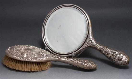 Appraisal: American parcel-gilt repousse silver hand mirror and hair brush possibly