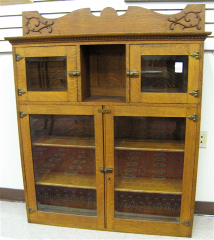 Appraisal: AN OAK CABINET BOOKCASE American c having two small beveled