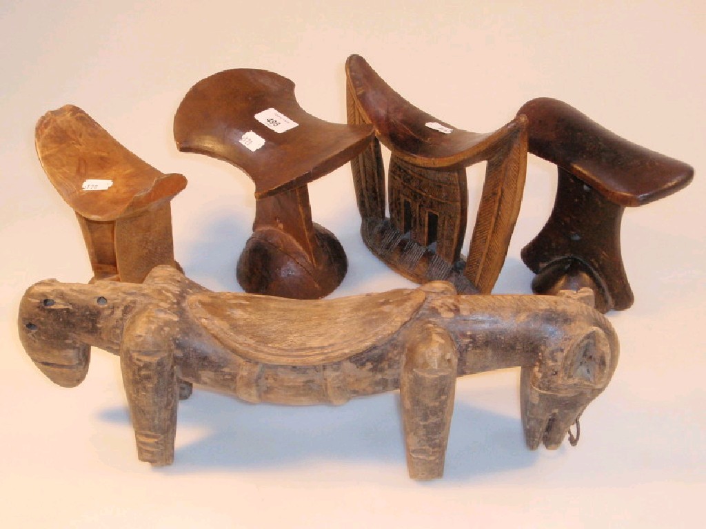 Appraisal: Five various ethnic carved wooden Tribal head rests