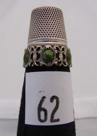 Appraisal: German silver thimble with green stones on band