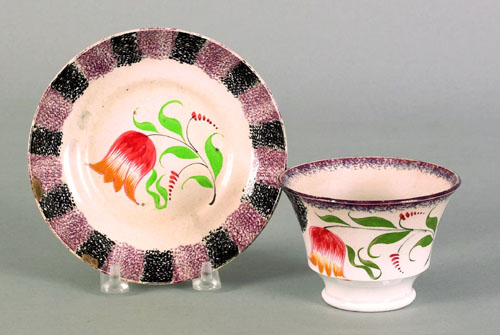 Appraisal: Black and purple rainbow spatter cup and saucer th c