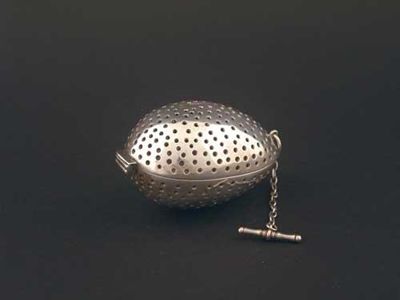 Appraisal: A Victorian oviform tea infuser hinging in half with suspensory