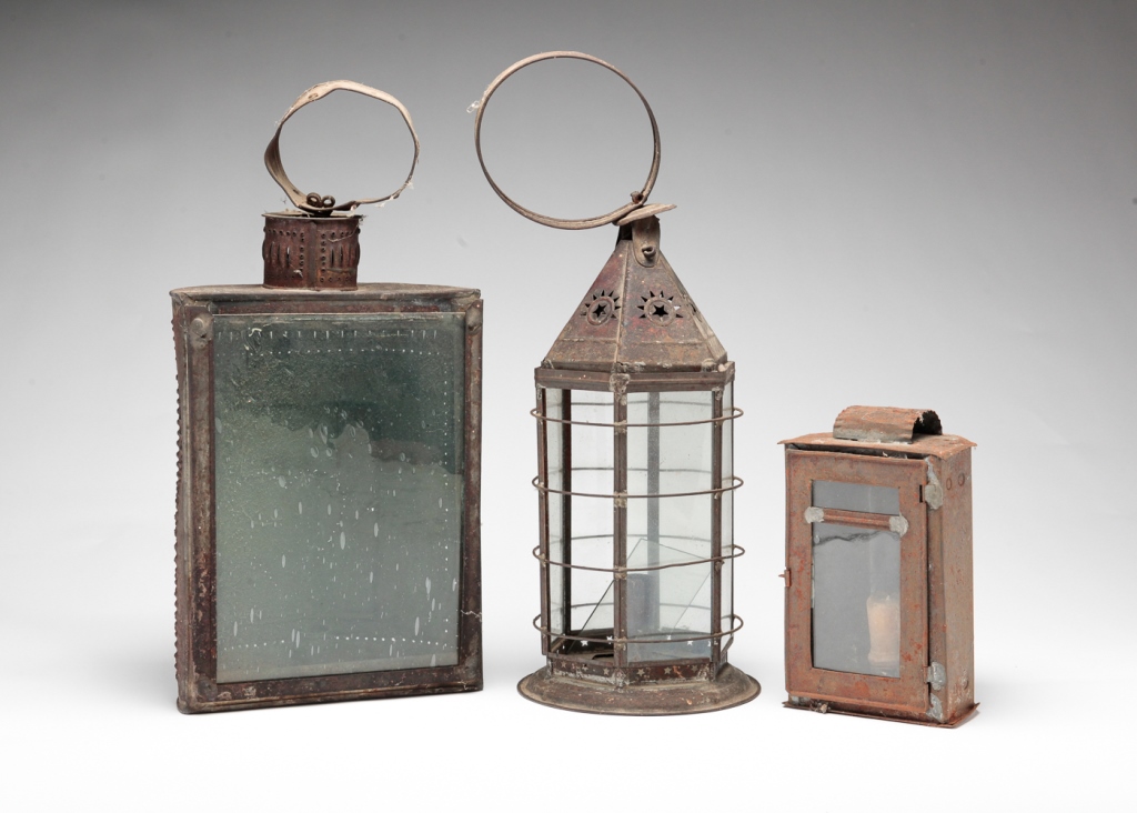 Appraisal: THREE AMERICAN TIN LANTERNS Nineteenth century Candle lanterns with glass