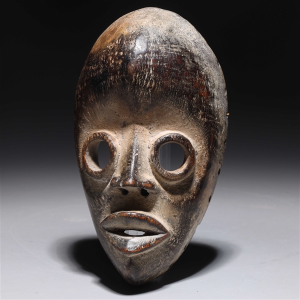 Appraisal: Carved wooden mask in the style of the Dan people