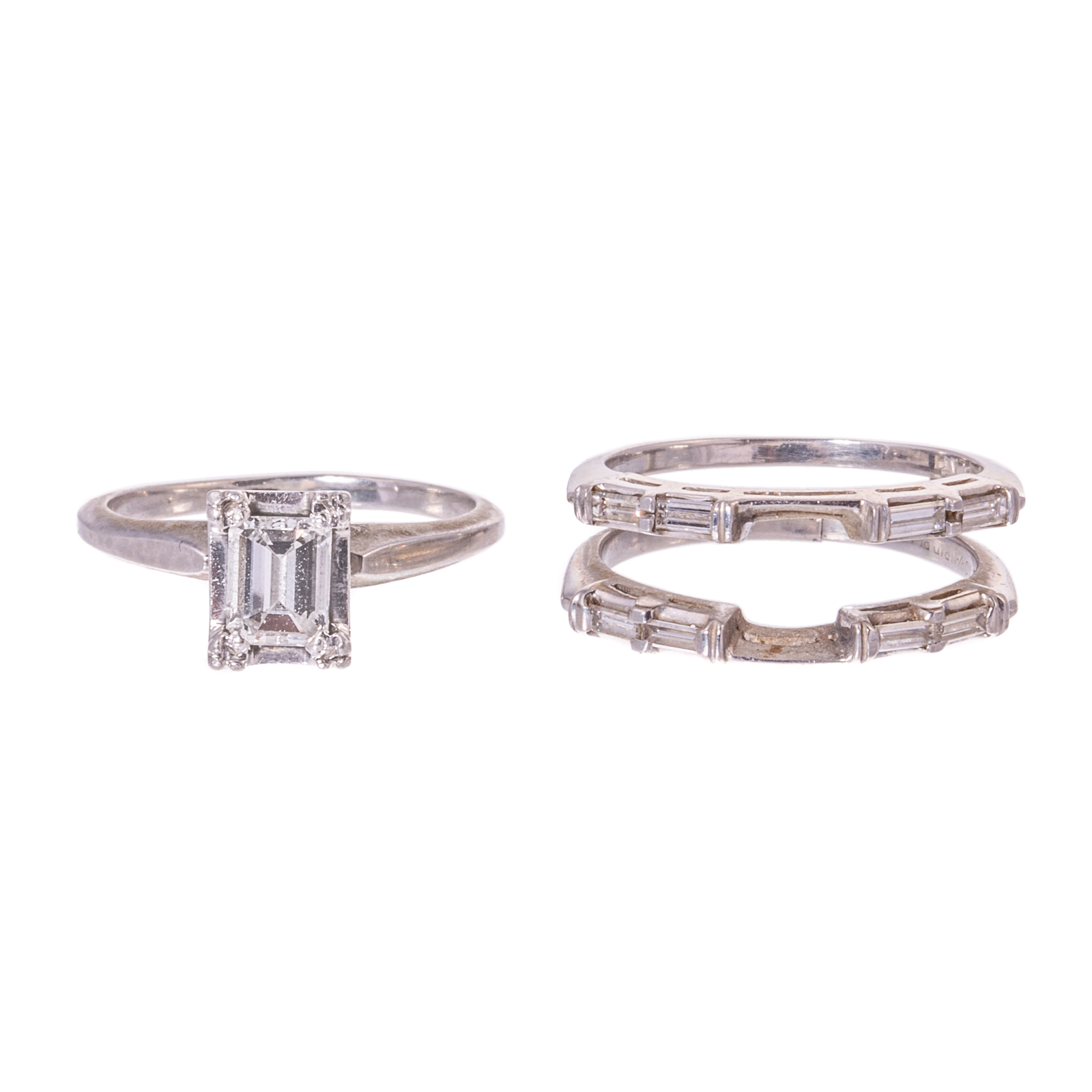 Appraisal: AN EMERALD-CUT DIAMOND RING ENHANCER IN PLATINUM Platinum ring featuring