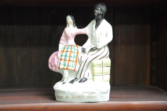 Appraisal: STAFFORDSHIRE EVA AND UNCLE TOM FIGURAL GROUP Having the standing