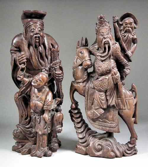 Appraisal: A Chinese hardwood carving of a Sage with young male