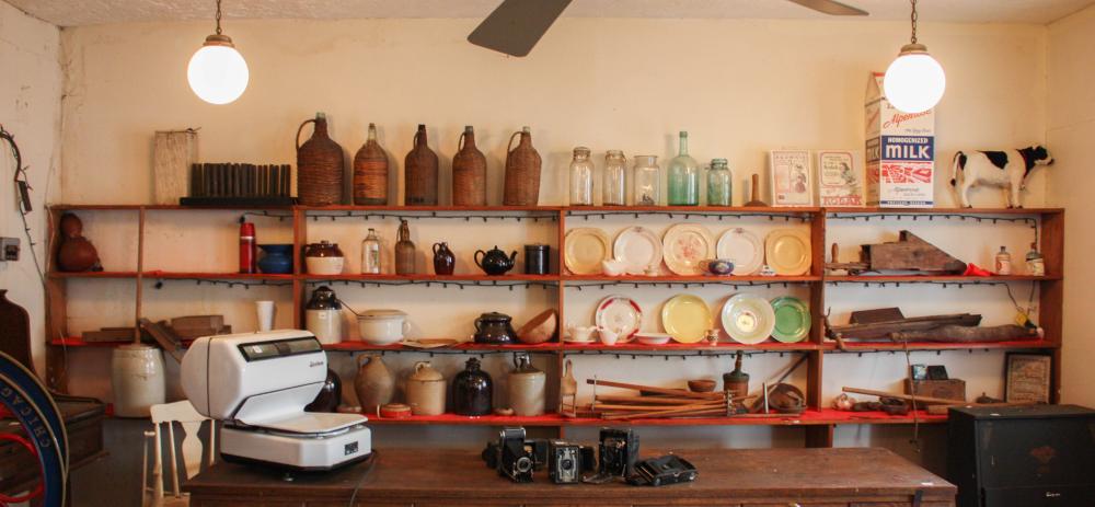 Appraisal: WALL OF ANTIQUES COLLECTIBLES ON SIXTEEN SHELVES jugs plates woodenware