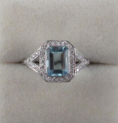 Appraisal: An aquamarine and diamond ring The emerald cut aquamarine is