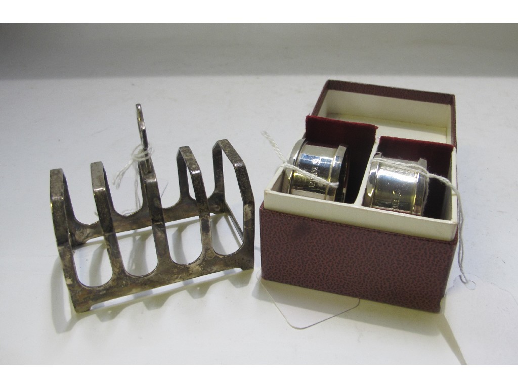 Appraisal: A lot comprising a silver toastrack and a boxed pair