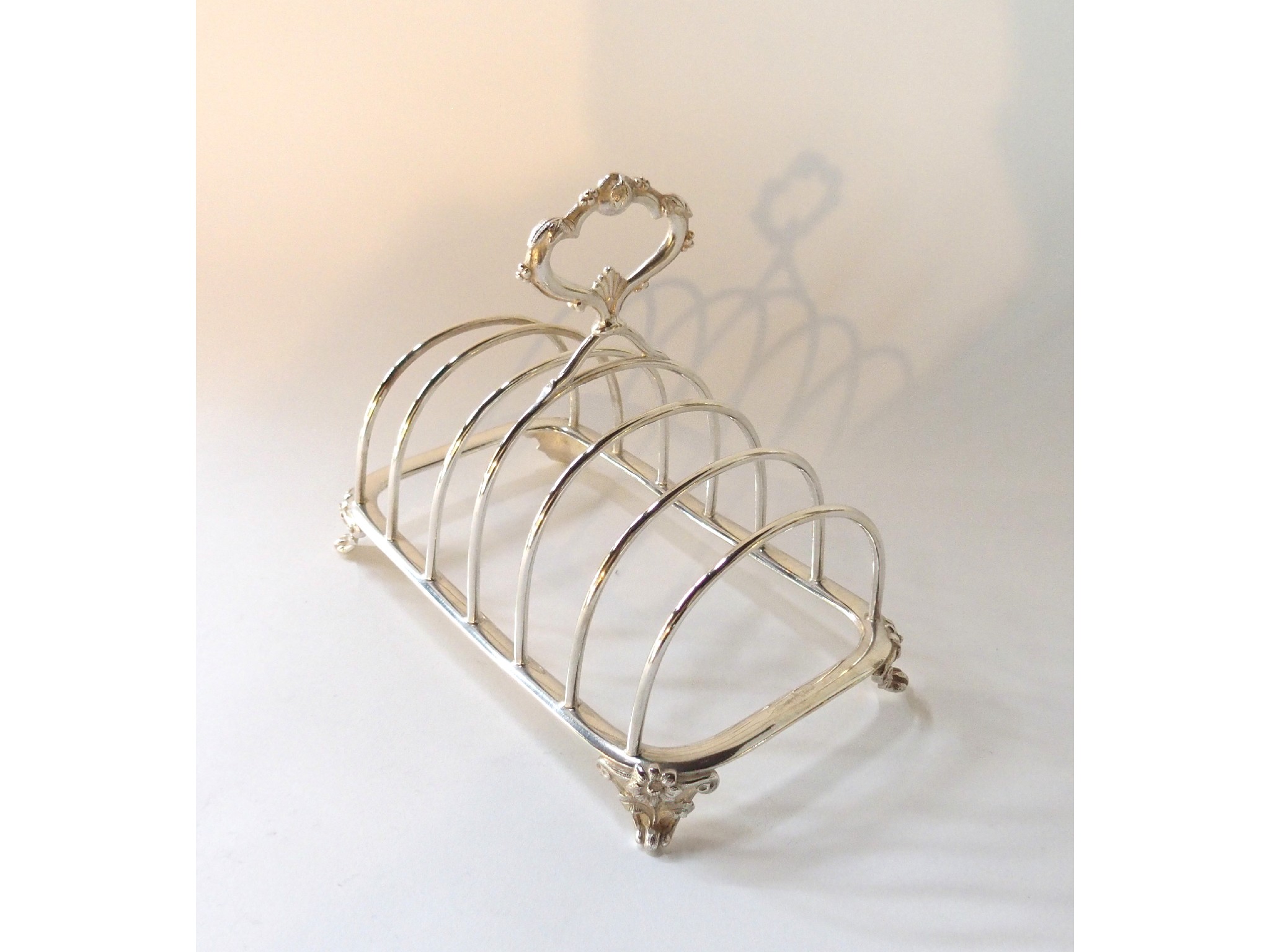 Appraisal: A continental white metal toastrack marked A Frenais an anchor