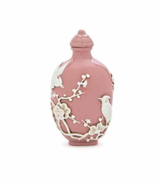 Appraisal: A Molded Porcelain Snuff Bottle the pink colored bottle having