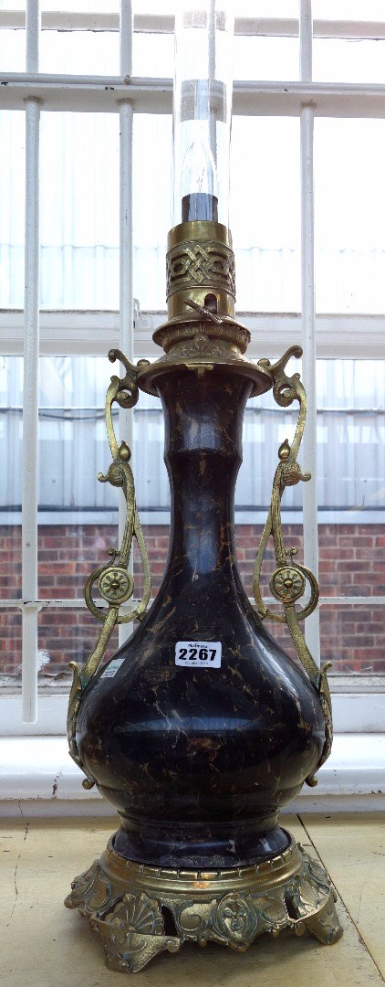 Appraisal: A marble and brass mounted table lamp converted early th