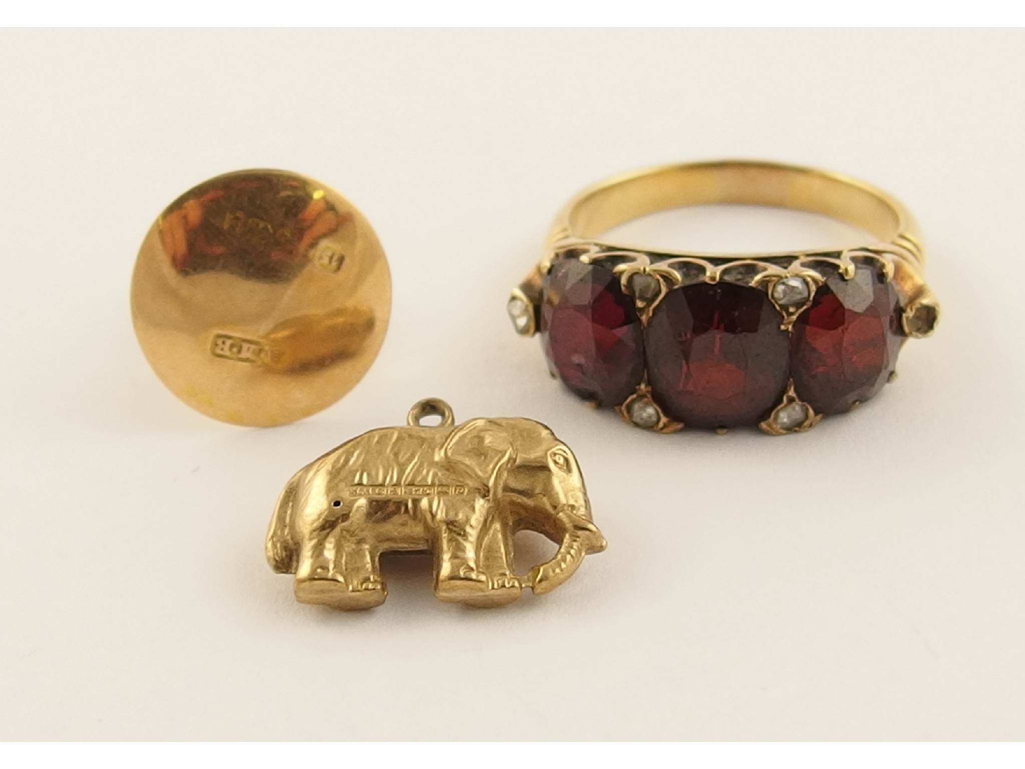 Appraisal: A yellow metal ring set with garnets and diamonds a