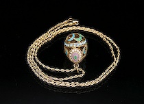 Appraisal: Russian Enameled Egg Pendant with Chain Pierced hollow egg-shaped pendant