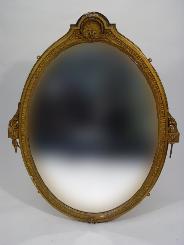 Appraisal: Oval gilded wood framed mirror with shell and acanthus mouldings