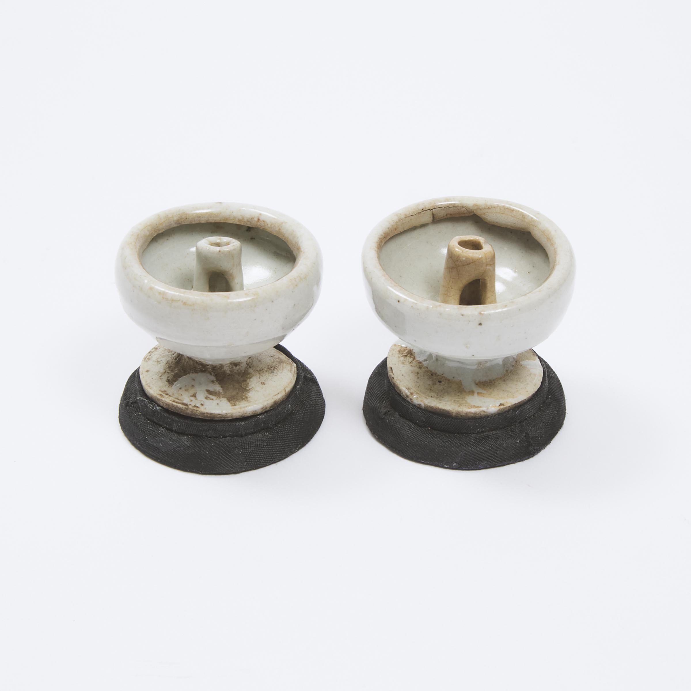 Appraisal: A Pair of Small White-Glazed Oil Lamp Stands Song Dynasty