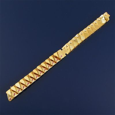 Appraisal: A gold bracelet with flexible links Displaying circular cut rubies