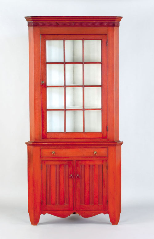 Appraisal: Pennsylvania red stained two-part corner cupboard ca the molded cornice