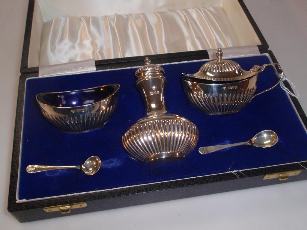 Appraisal: A five-piece silver boat shape cruet set with fluted bodies