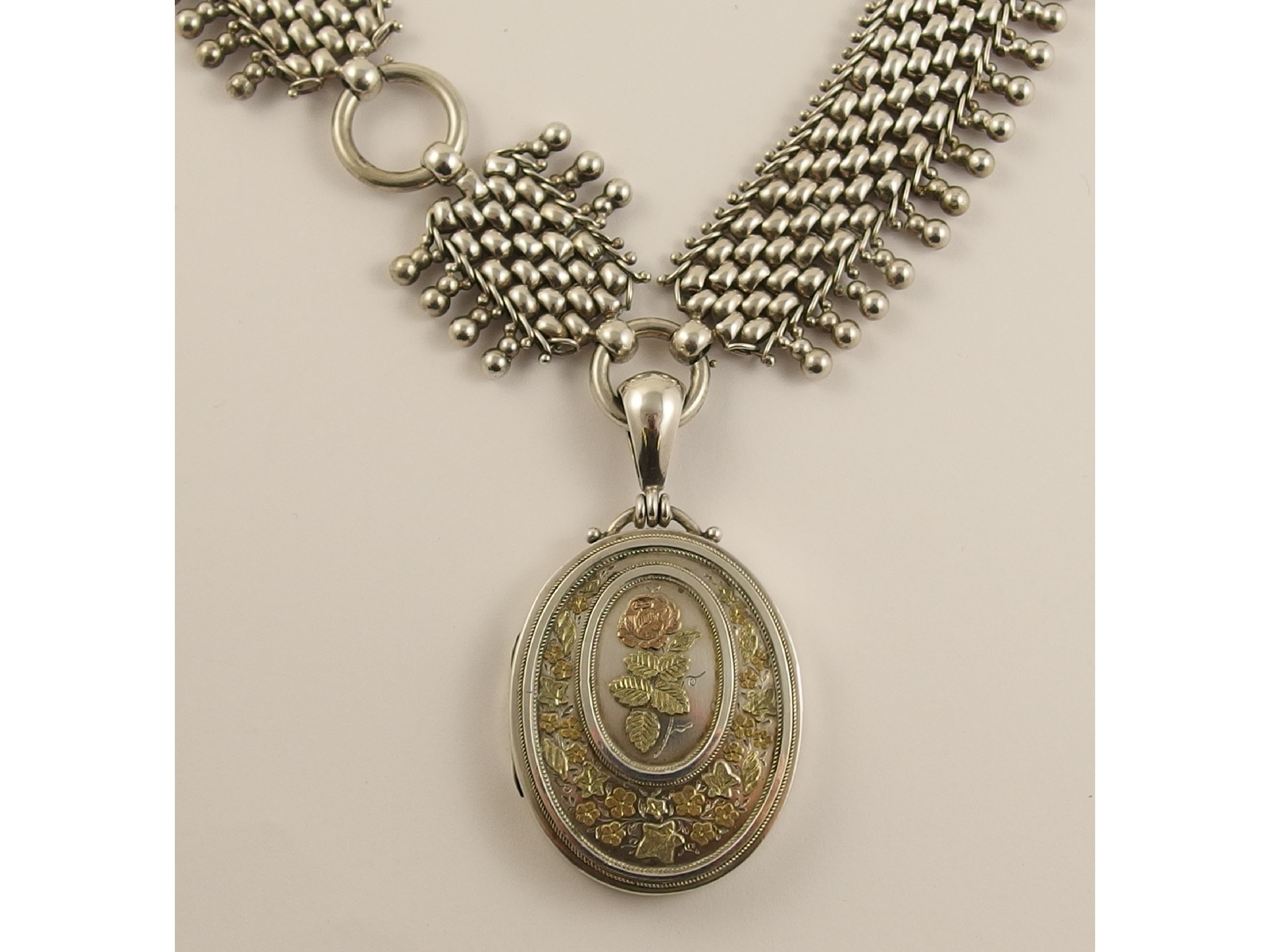 Appraisal: A silver Victorian locket and decorative chainthe locket is decorated