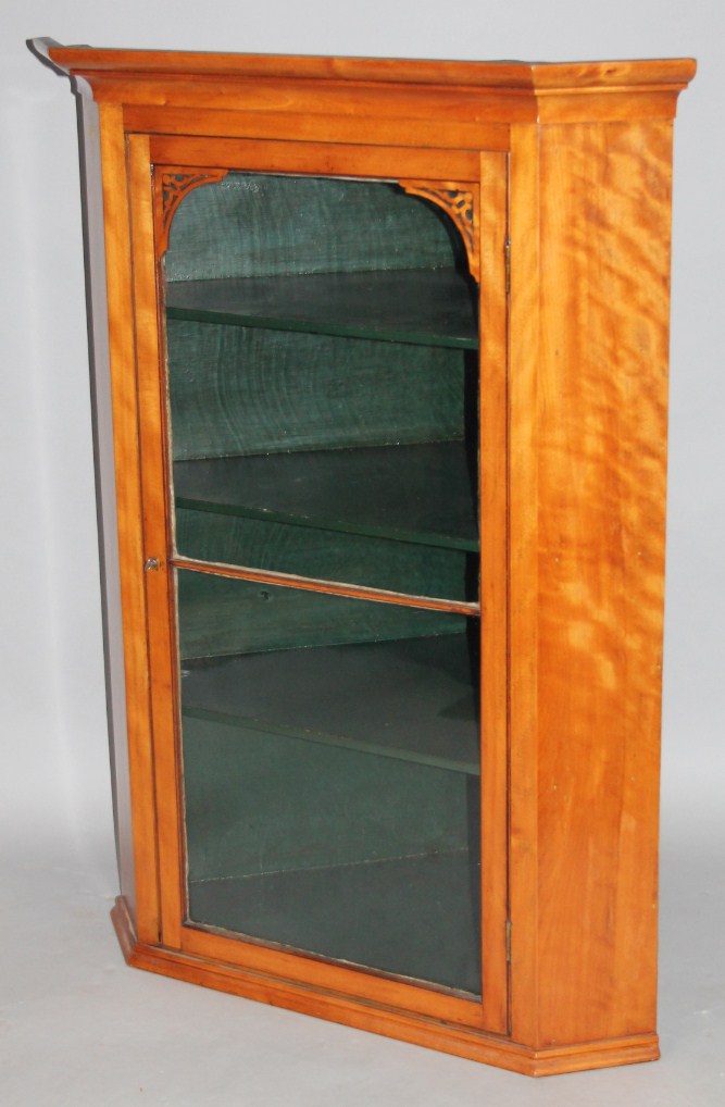 Appraisal: A thC satinwood hanging corner cabinet with a plain glazed