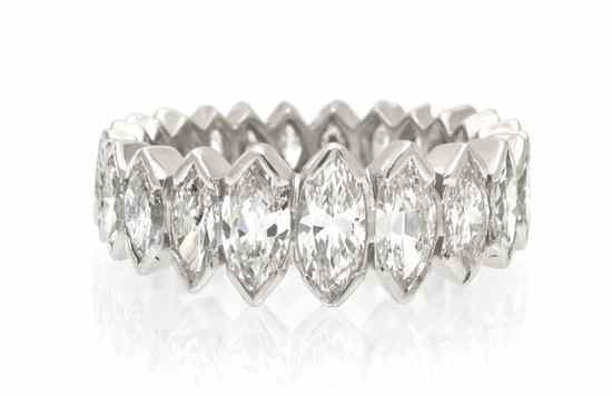 Appraisal: A Graduated Platinum and Diamond Eternity Band containing marquise cut