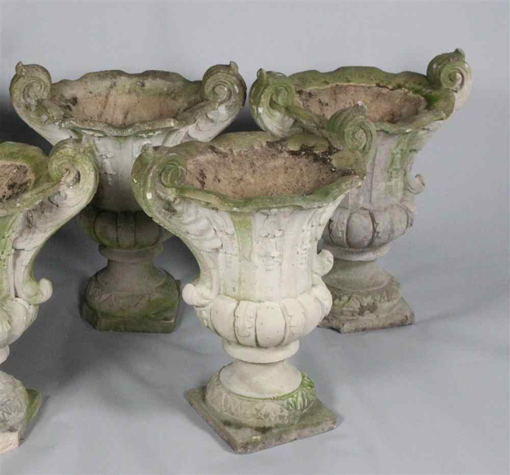 Appraisal: THREE CAST STONE GARDEN URNS each urn with boldly scrolled