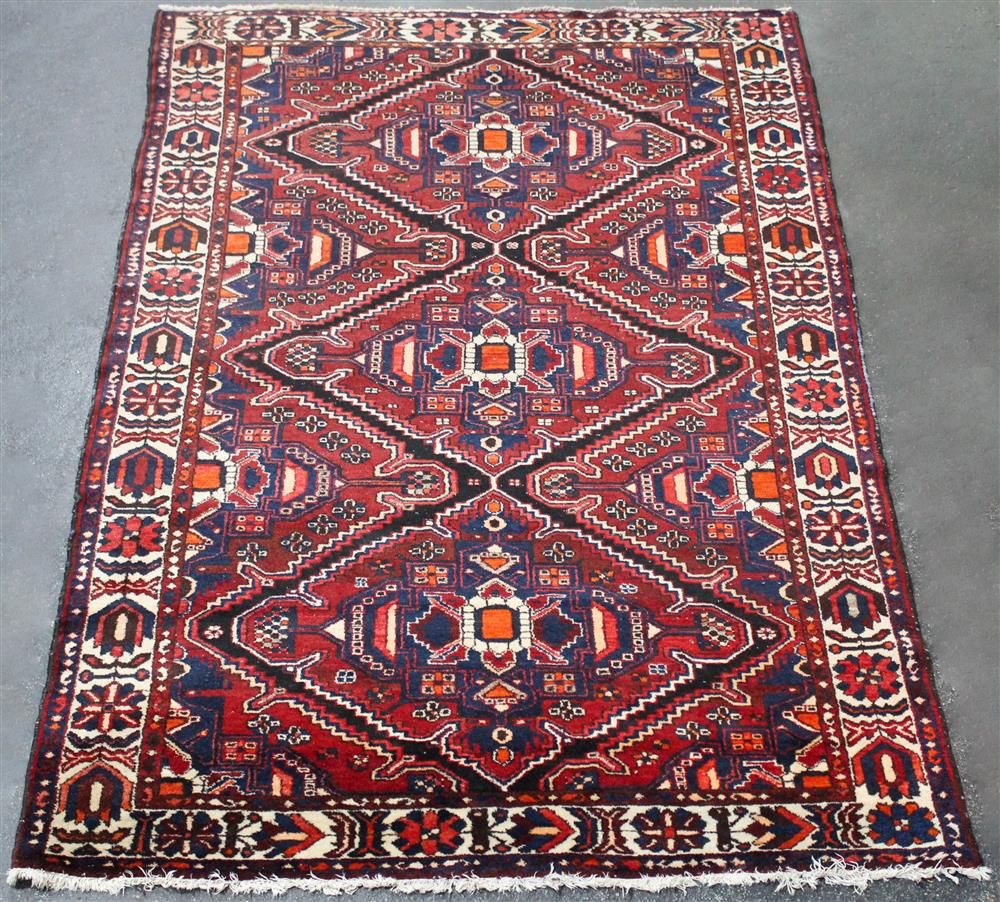 Appraisal: THREE MEDALLION ORIENTAL WOOL RUG cotton fringe to ends colors