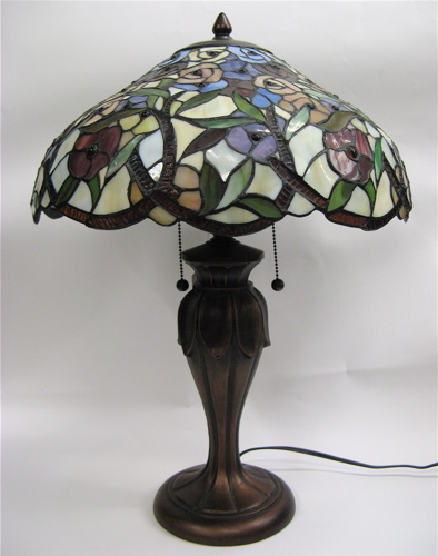 Appraisal: A STAINED AND LEADED GLASS TABLE LAMP in a floral