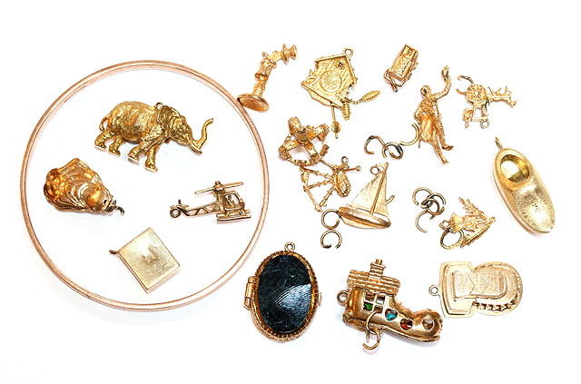 Appraisal: A COLLECTION OF SIXTEEN GOLD CHARMS various and a ct